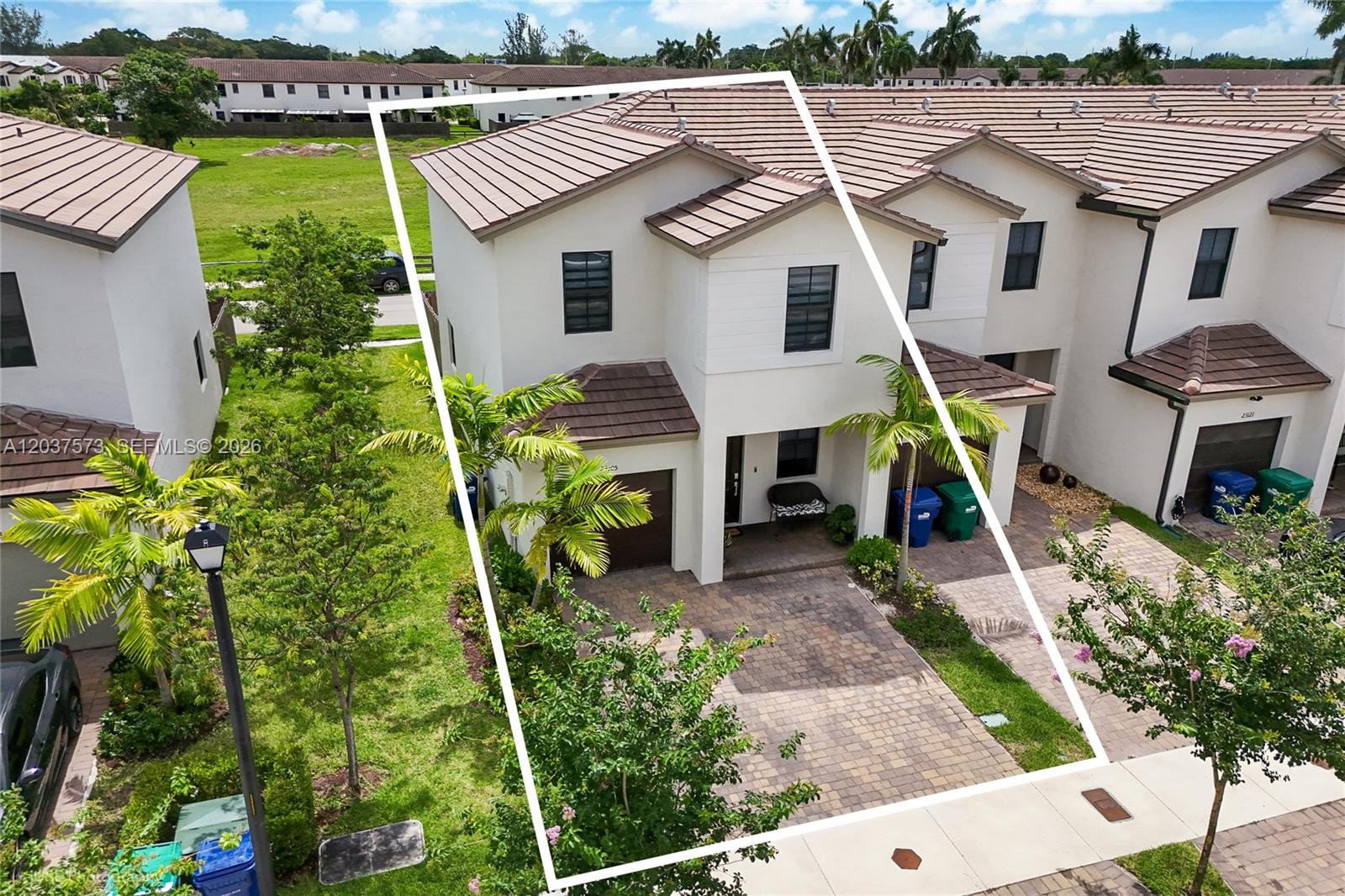 An aerial view shows a two-story townhouse with a paved driveway and tiled roof — 23105 SW 128th Pl # 23105, Miami FL 33170, MIAMI, FL