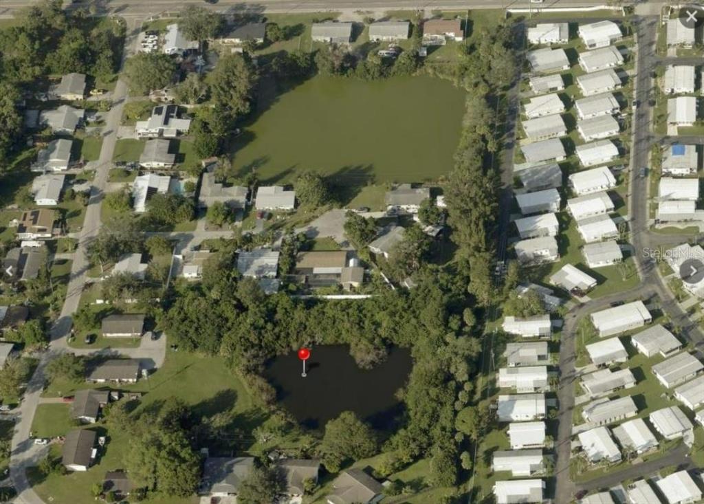 This aerial view shows a residential neighborhood with two ponds and a marked location — ALGERIA COURT, BRADENTON, FL