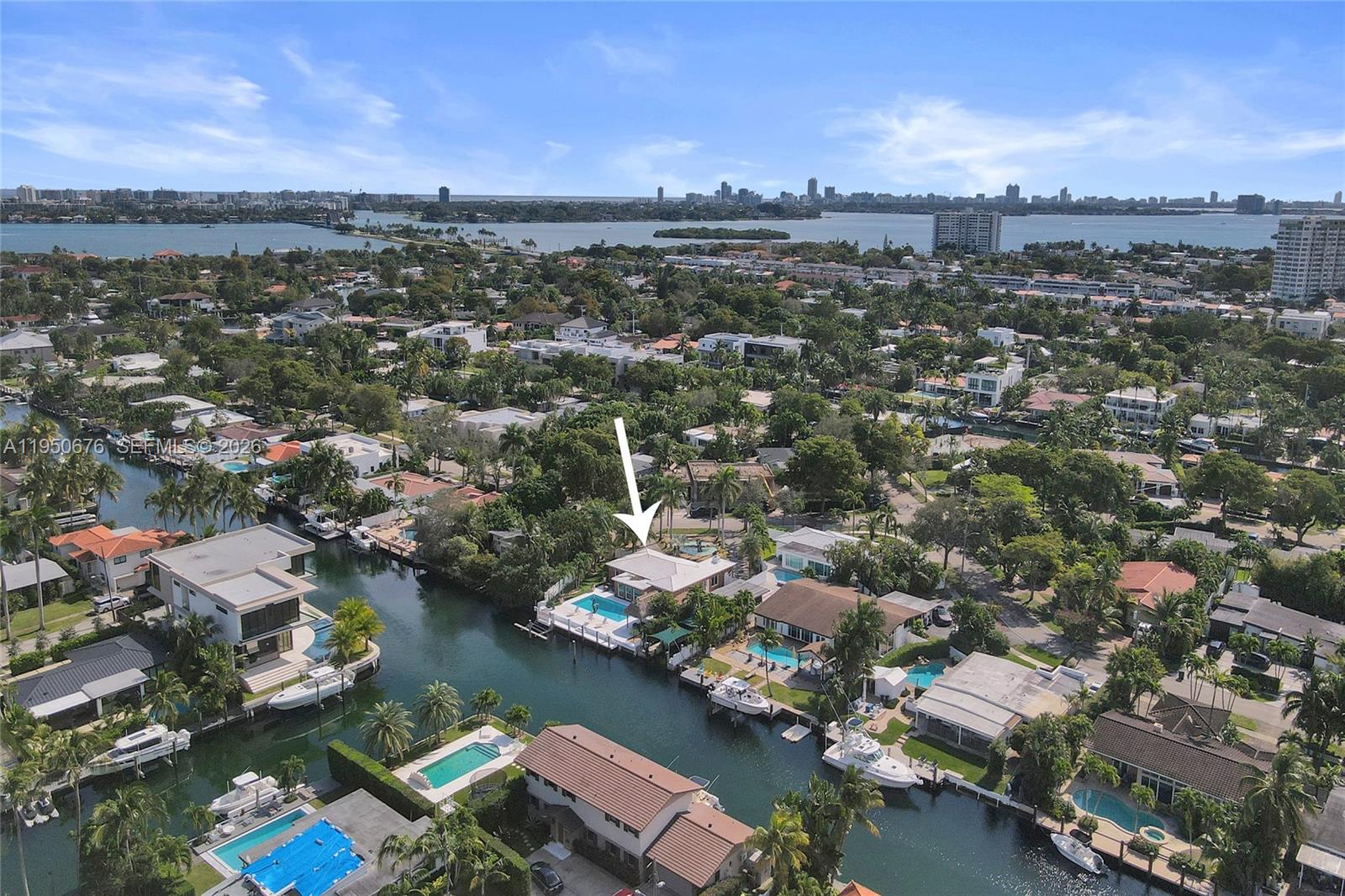 An aerial view shows a waterfront house with a swimming pool and a boat dock — 1995 N Hibiscus Dr, North Miami FL 33181, NORTH MIAMI, FL
