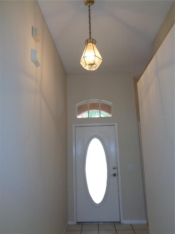 An entryway features a white door with an oval window, a transom, and a pendant light — 2125 RIVER PARK BOULEVARD, ORLANDO, FL