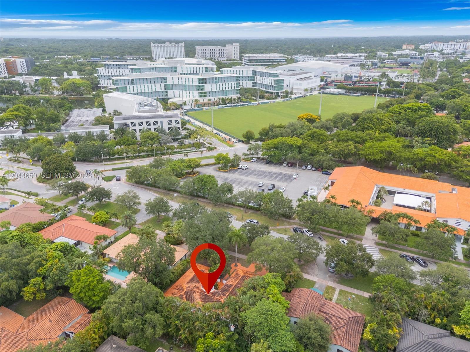 An aerial view shows a residential house with a red-tiled roof marked by a pin — 1439 Miller Rd, Coral Gables FL 33146, CORAL GABLES, FL