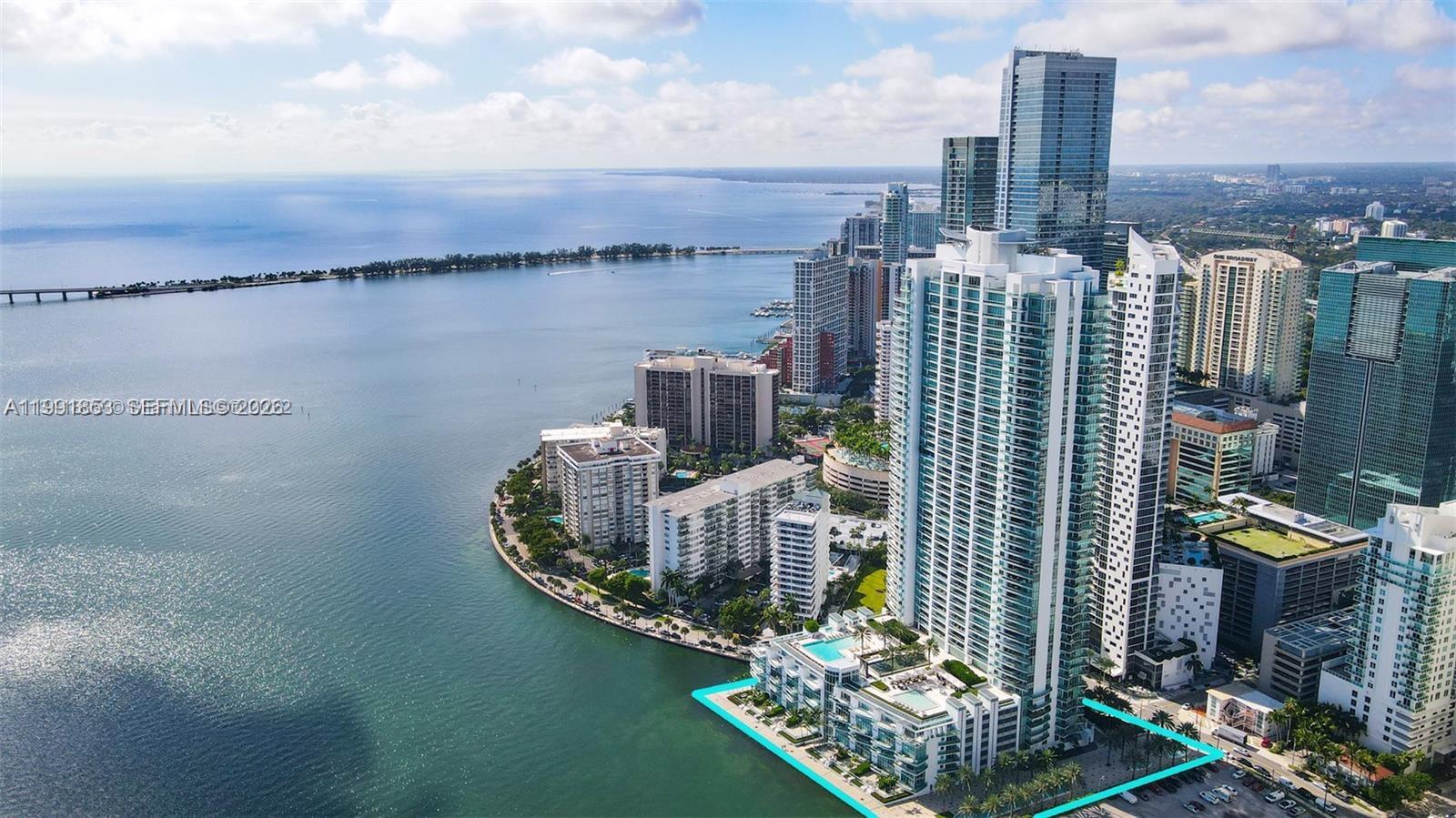 An aerial view shows a waterfront high-rise residential complex in a dense urban area — 1331 Brickell Bay Dr # 903, Miami FL 33131, MIAMI, FL