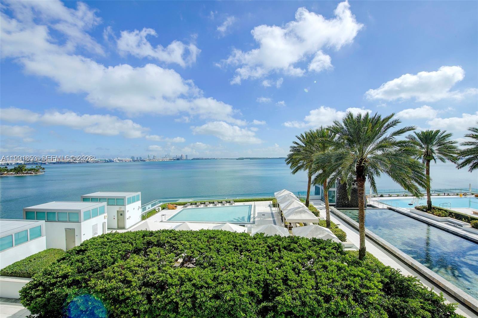 An elevated view shows a swimming pool deck with palm trees overlooking the ocean — 1331 Brickell Bay Dr # 903, Miami FL 33131, MIAMI, FL