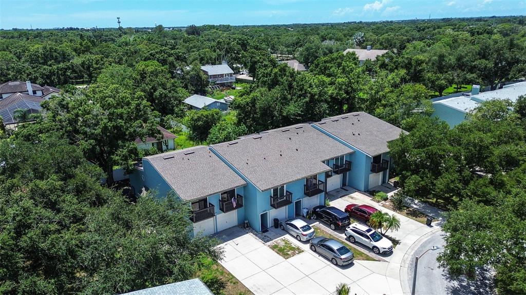 An aerial view shows a multi-unit townhouse building with blue siding and a gray roof — 6334 92ND PLACE N UNIT 2401, PINELLAS PARK, FL