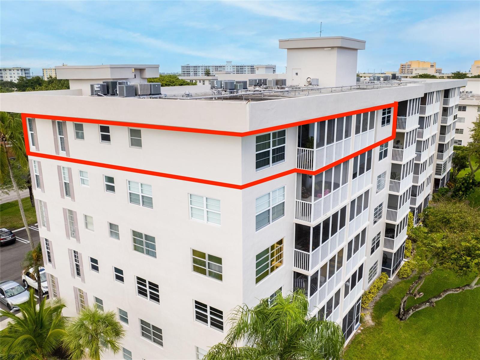 An aerial view of a multi-story apartment building with a red outline highlighting the top-floor unit — 2850 N Palm Aire Drive # 601, Pompano Beach FL 33069, POMPANO BEACH, FL