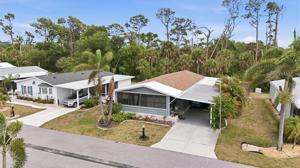 An aerial view shows two manufactured homes with carports and palm trees in a neighborhood — 807 SEABROOKE DRIVE, ENGLEWOOD, FL