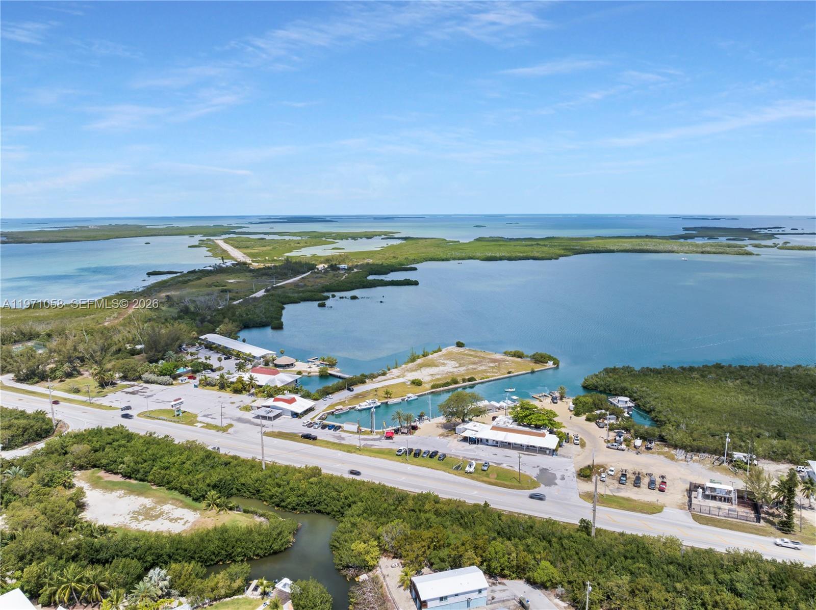 An aerial view shows a coastal property with a marina, parking lot, and buildings — 17075 Overseas Highway, Sugarloaf FL 33042, SUGARLOAF, FL