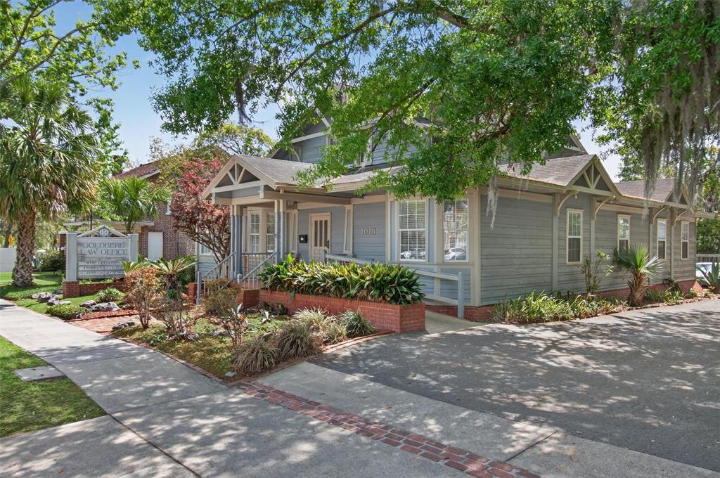 A gray, two-story building with a front porch and a law office sign — 1013 SW 2ND AVENUE, GAINESVILLE, FL
