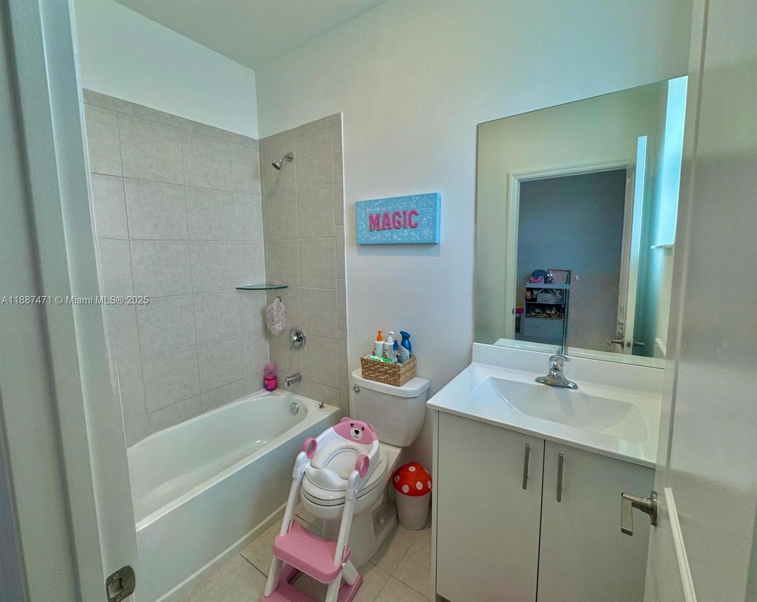 A bathroom features a white vanity, a toilet with a child's seat, and a tub-shower — 23541 SW 127th Pl, Homestead FL 33032, HOMESTEAD, FL