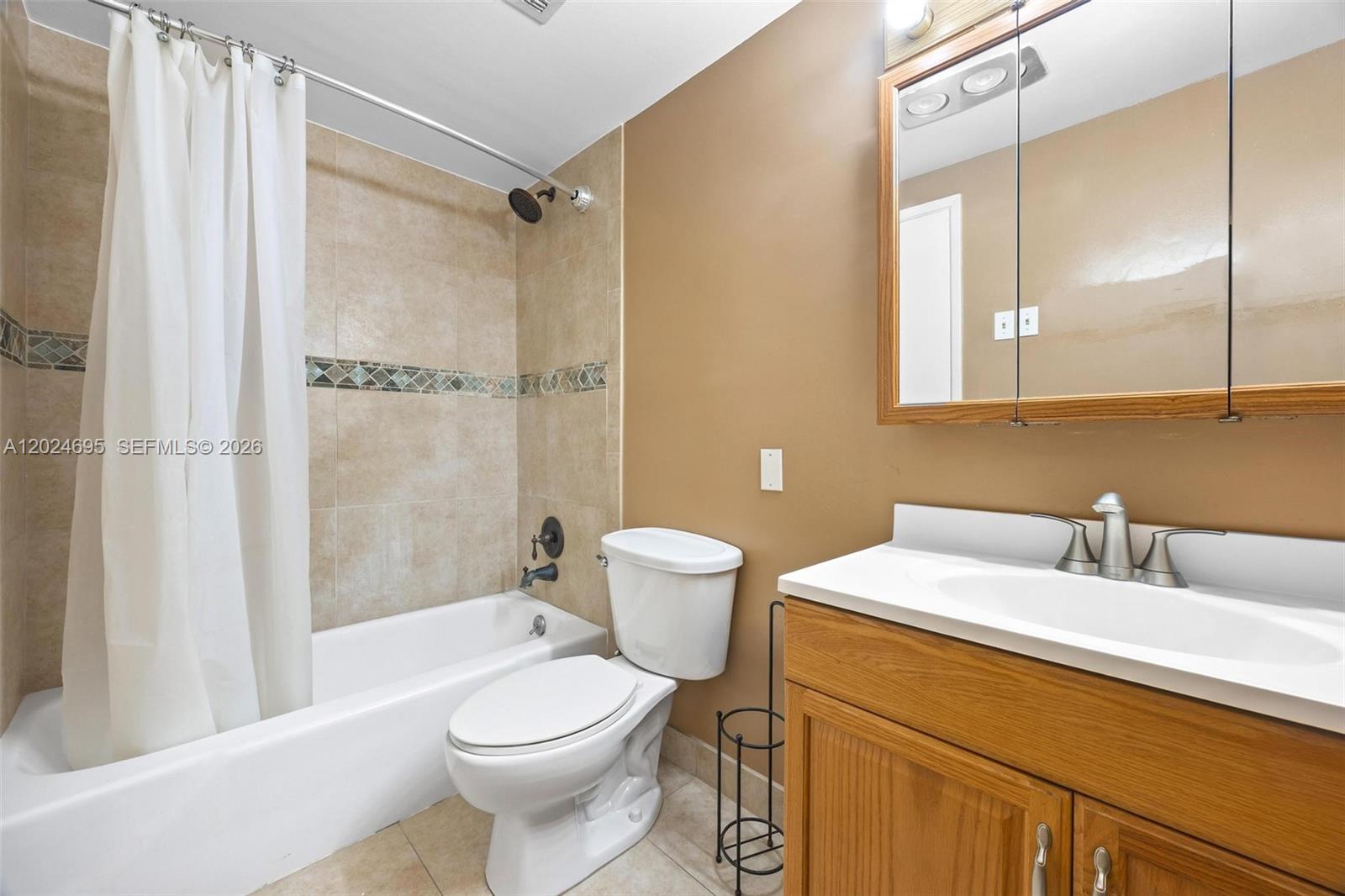 A bathroom features a tub-shower combination, a white toilet, and a wooden vanity cabinet — 4350 Hillcrest Dr # 1016, Hollywood FL 33021, HOLLYWOOD, FL