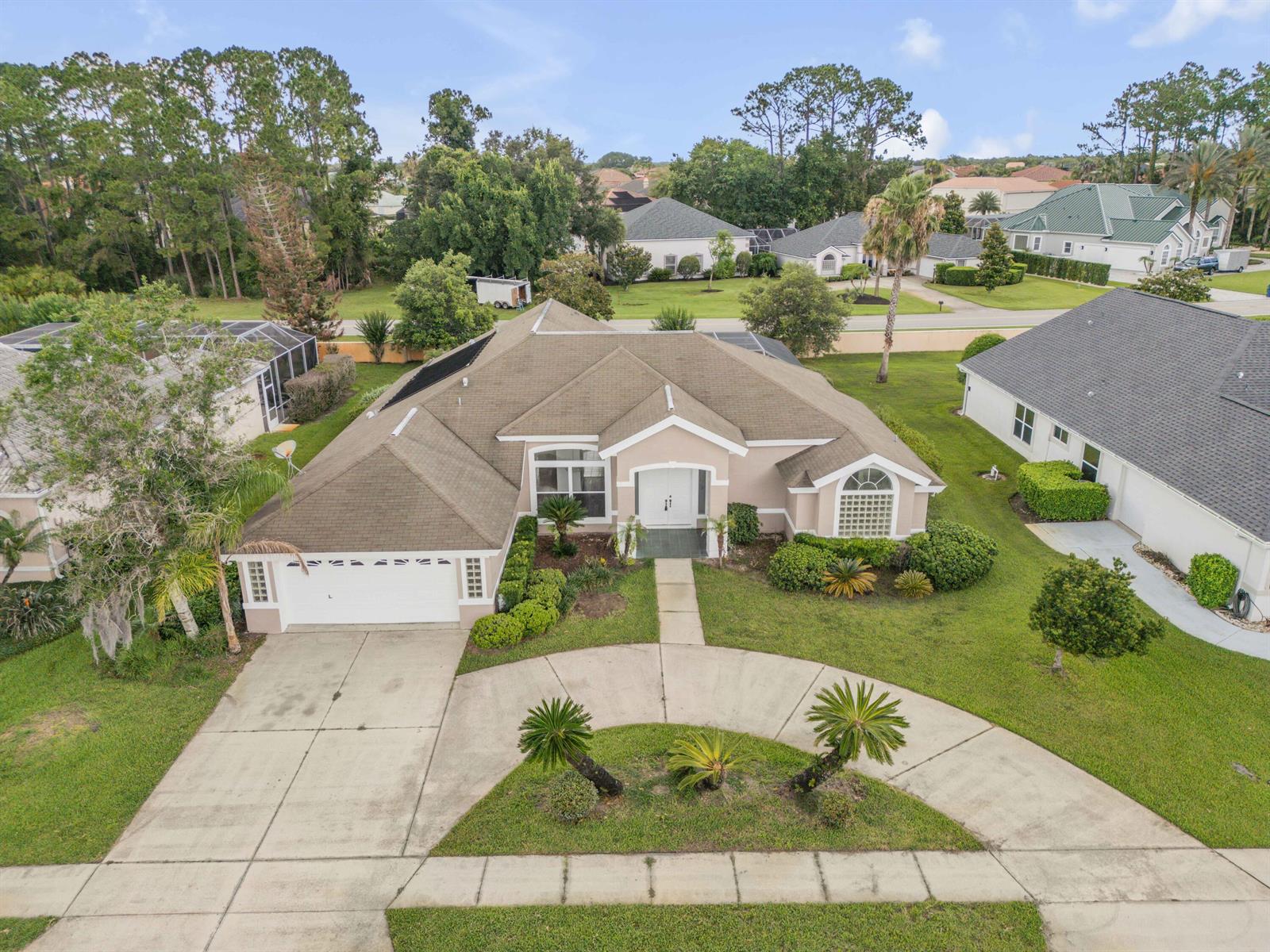 An aerial view of a single-story suburban house with a driveway and landscaped front yard — 2911 Cypress Ridge Trail, Port Orange FL 32128, PORT ORANGE, FL