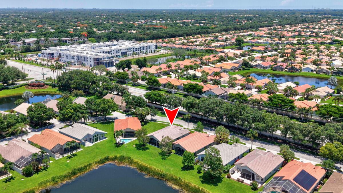 An aerial view shows a residential neighborhood with houses, a lake, and a red arrow — 11709 Castellon Court, Boynton Beach FL 33437, BOYNTON BEACH, FL