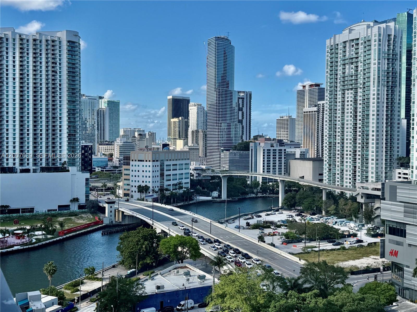 An elevated view of a Miami cityscape featuring high-rise buildings, a bridge, and a river — 88 SW 7th St # 1109, Miami FL 33130, MIAMI, FL
