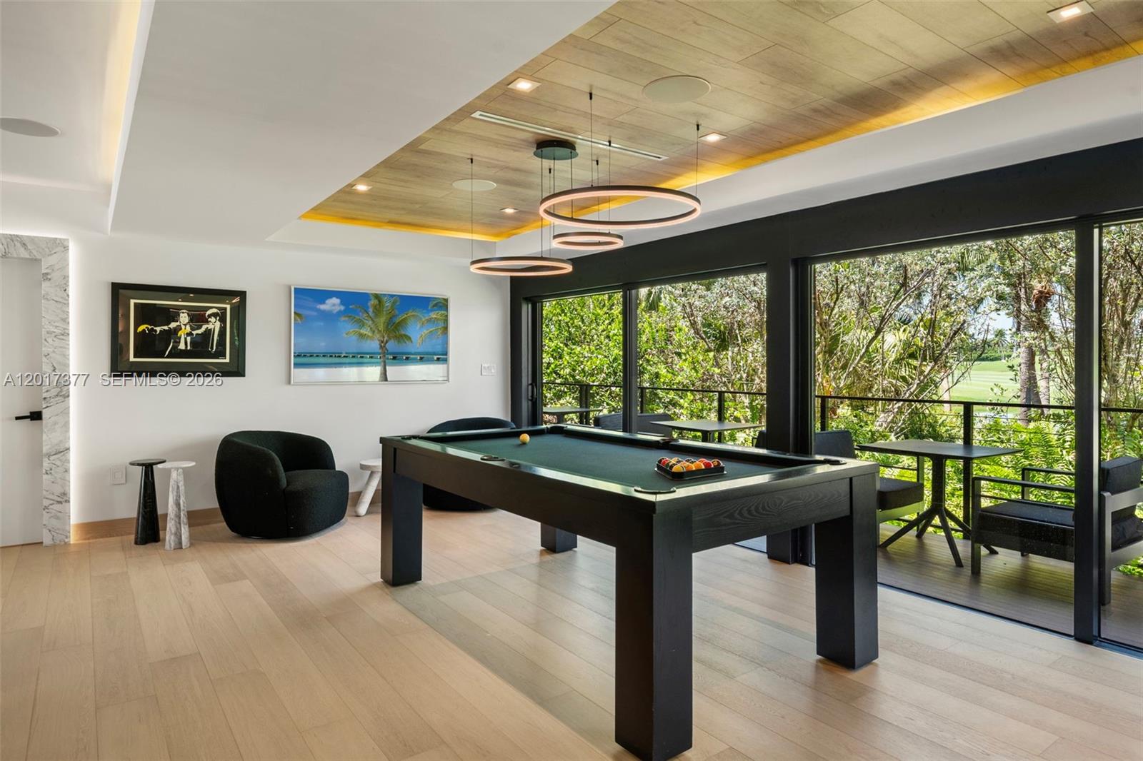 A game room features a pool table, modern circular pendant lights, and a wooden ceiling — 5750 La Gorce Dr, Miami Beach FL 33140, MIAMI BEACH, FL