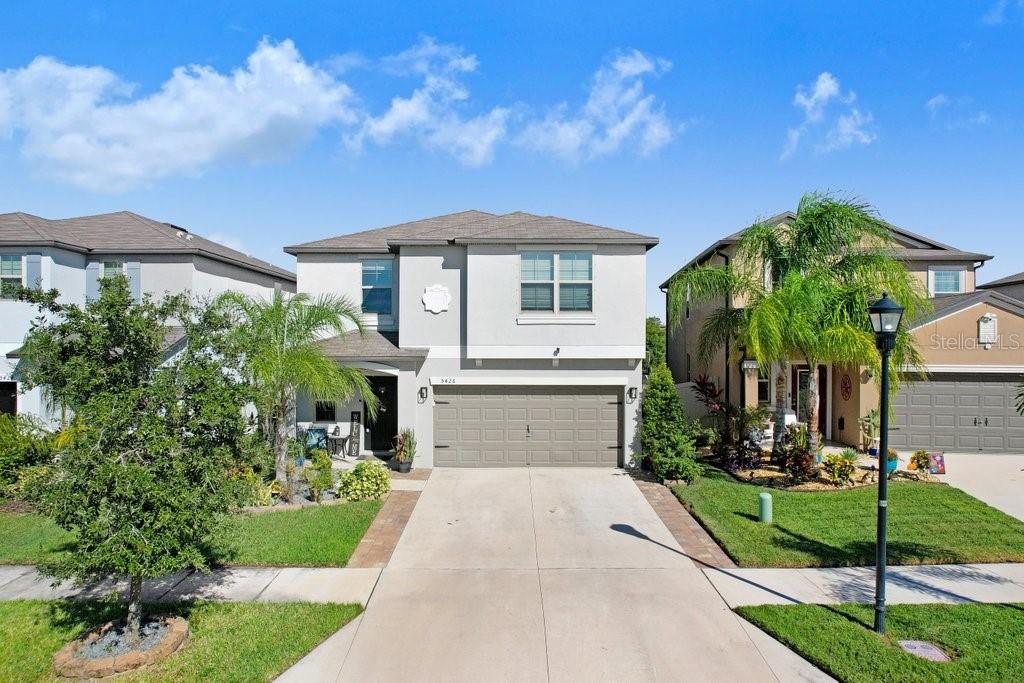 A two-story suburban house with a gray garage and a paved driveway — 5426 RAINWOOD MEADOWS DRIVE, APOLLO BEACH, FL