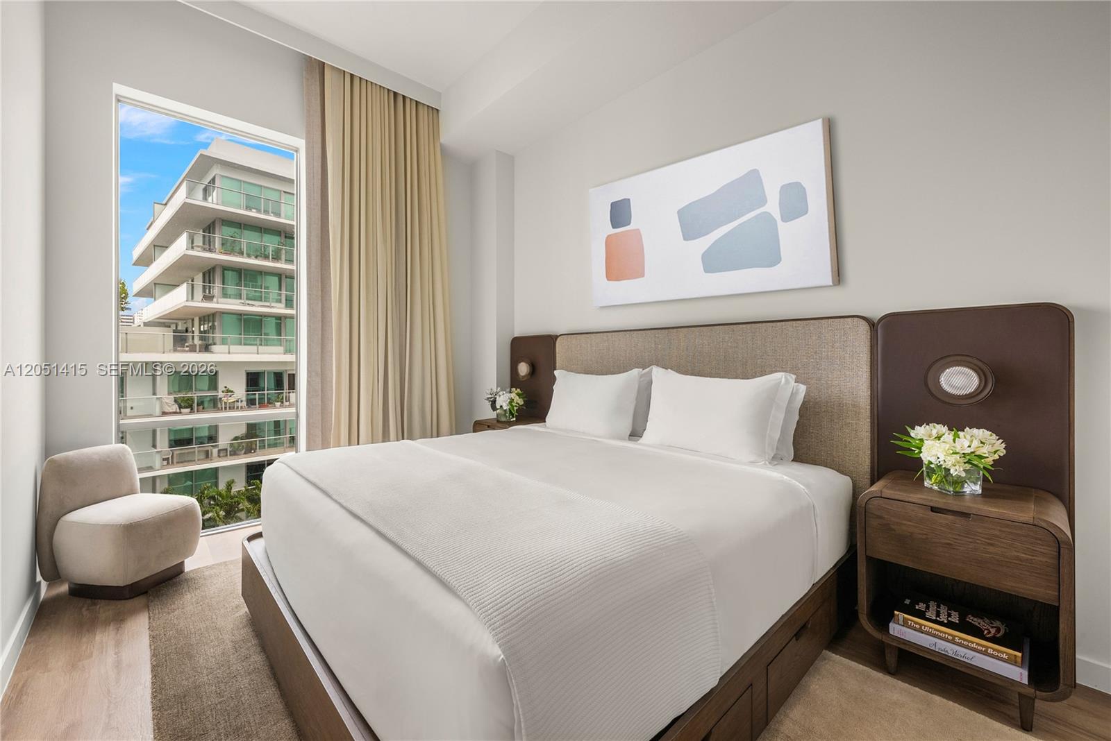 A modern bedroom features a queen bed, wooden nightstands, and a floor-to-ceiling window — 1611 SW 2nd Ave # 516, Miami FL 33129, MIAMI, FL
