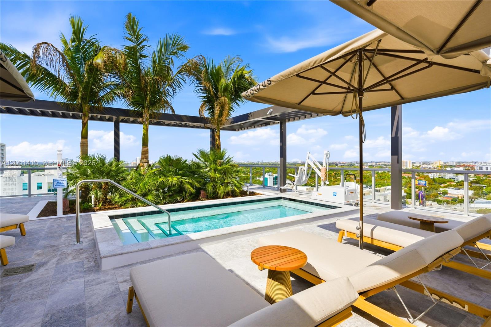 A rooftop terrace features a small rectangular pool, lounge chairs, and palm trees under umbrellas — 1611 SW 2nd Ave # 516, Miami FL 33129, MIAMI, FL