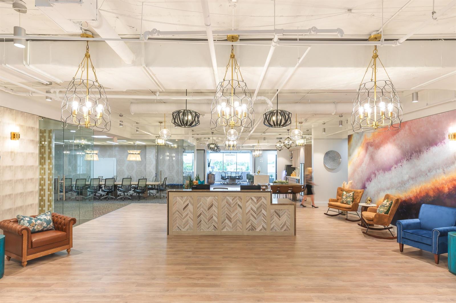 A modern office lobby features a reception desk, lounge seating, and decorative pendant lighting — 1200 N Federal, Boca Raton FL 33432, BOCA RATON, FL