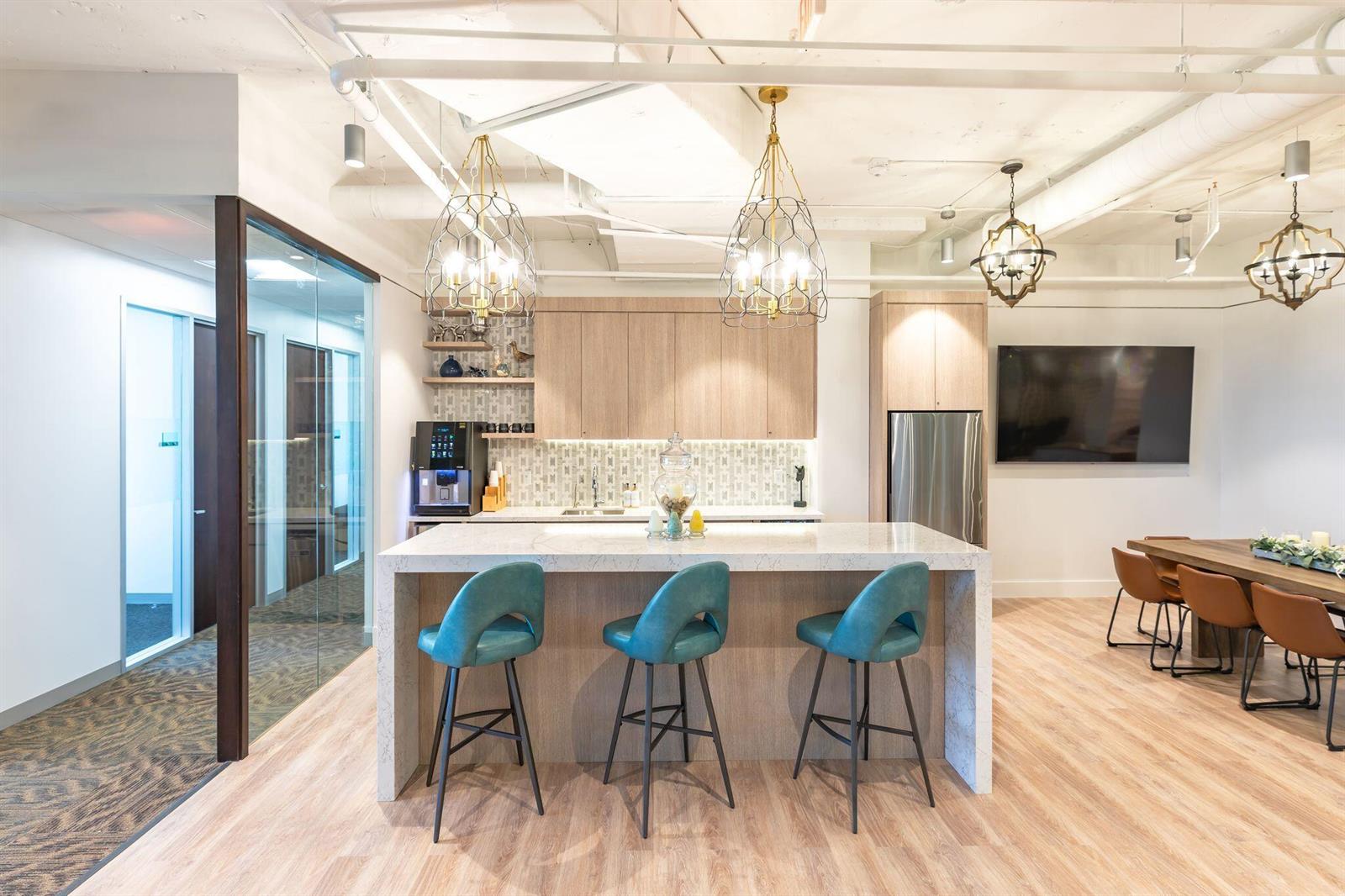 A modern office kitchen features a marble-topped island with three teal stools and pendant lighting — 1200 N Federal, Boca Raton FL 33432, BOCA RATON, FL