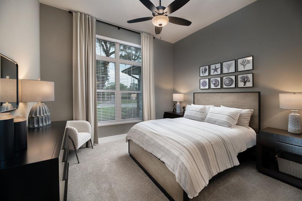 A bedroom features a bed, two nightstands, a dresser, a ceiling fan, and a window — 0000 SE 47TH LOOP, OCALA, FL