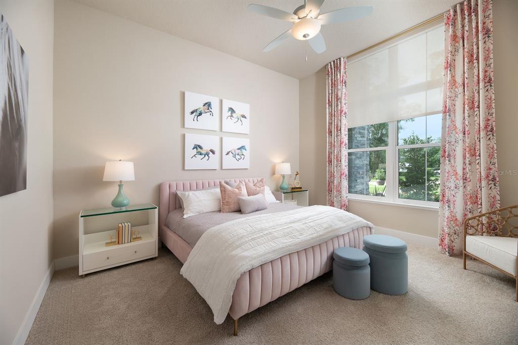 A bedroom features a pink upholstered bed, four horse prints, and floral curtains by a window — 0000 SE 47TH LOOP, OCALA, FL
