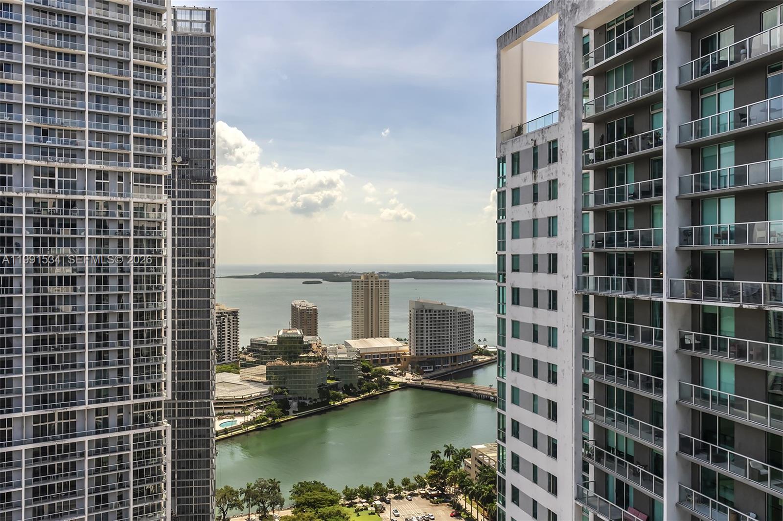 An elevated view of a bay surrounded by high-rise buildings and a bridge — 77 SE 5th Street # 2403, Miami FL 33131, MIAMI, FL
