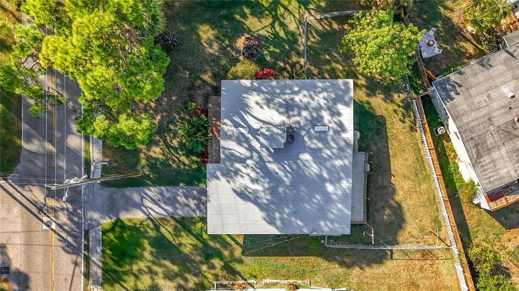 An aerial view shows a house with a flat roof, a chimney, and a driveway — 5051 AVERY ROAD, NEW PORT RICHEY, FL