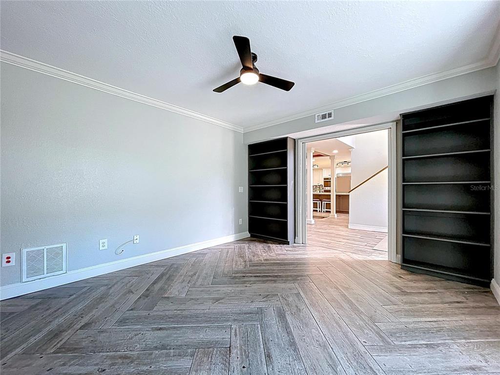 A bright entryway features double front doors, a glass block window, and wood-look tile flooring — 10655 LAKEVIEW DRIVE, NEW PORT RICHEY, FL