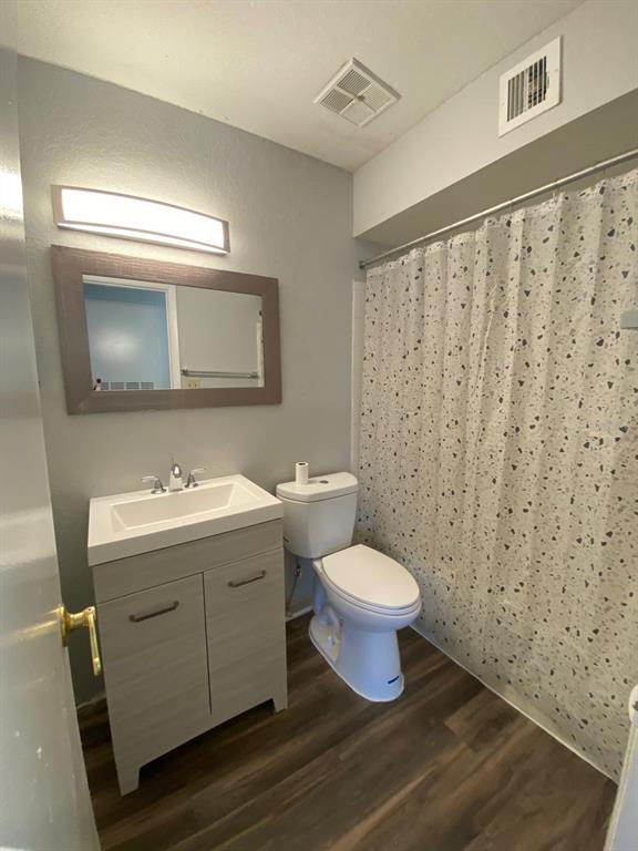 A bathroom features a vanity with a white sink, a toilet, and a shower curtain — 4400 THORNBRIAR LANE UNIT 205, ORLANDO, FL