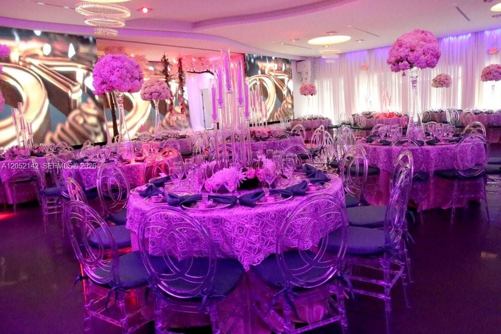 A banquet hall features round tables with purple linens, clear chairs, and tall floral centerpieces — 2717 SW 142nd Ave, Miami FL 33175, MIAMI, FL