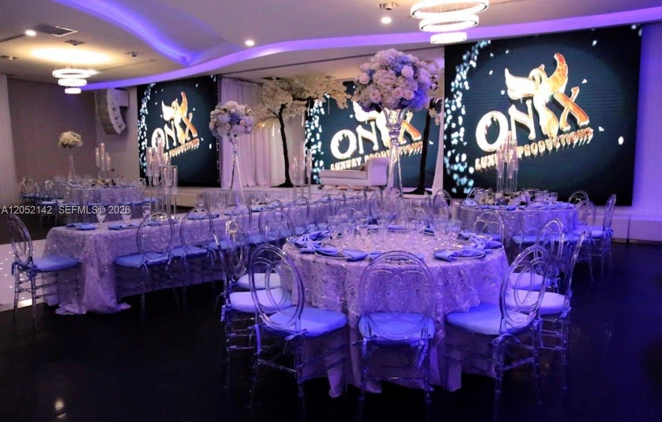 A banquet hall features round tables with lace tablecloths, clear chairs, and large digital screens — 2717 SW 142nd Ave, Miami FL 33175, MIAMI, FL