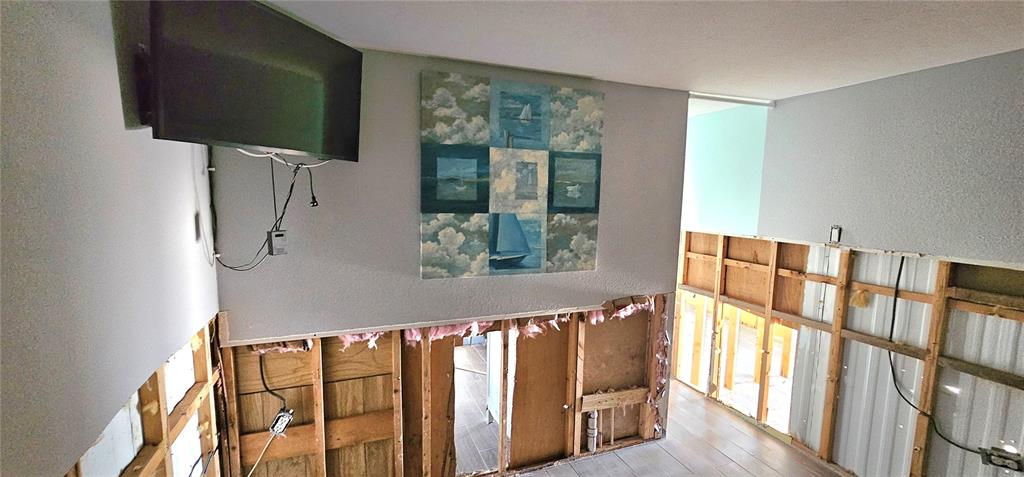 An interior view shows a room under construction with exposed wall studs and unfinished drywall — 41 2ND STREET, BRADENTON, FL