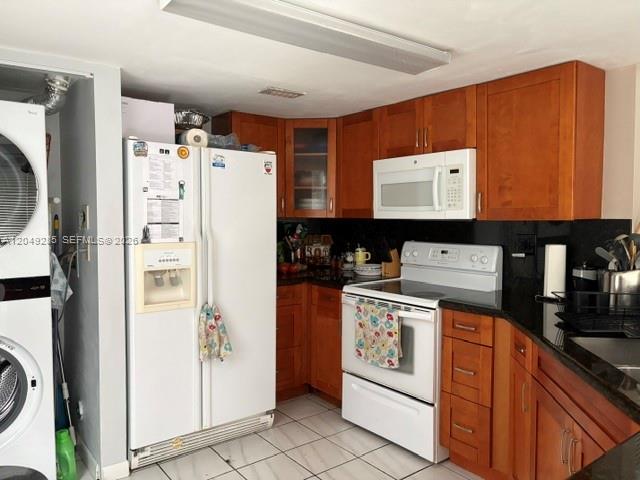 A kitchen features wooden cabinets, a white refrigerator, and a white stove — 415 NW 85th Pl # 1701, Miami FL 33126, MIAMI, FL