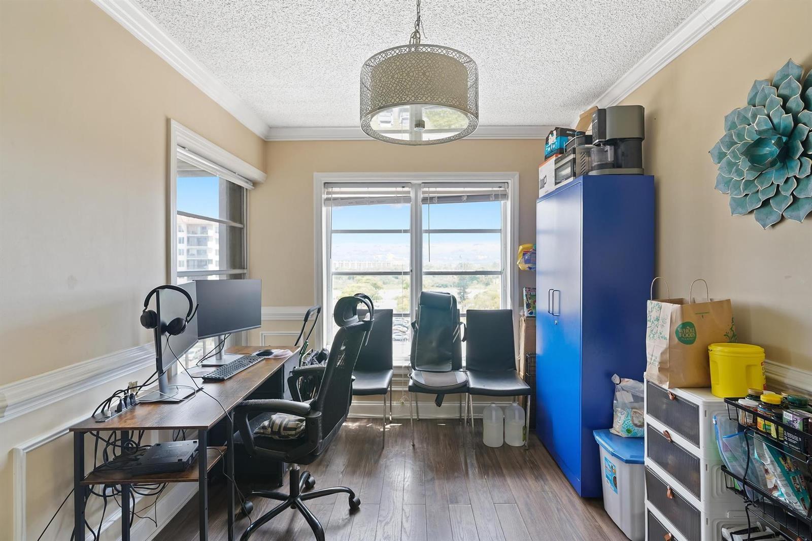 A home office features a desk, computer, blue storage cabinet, and a view of buildings — 4174 Inverrary Drive # 701, Lauderhill FL 33319, LAUDERHILL, FL