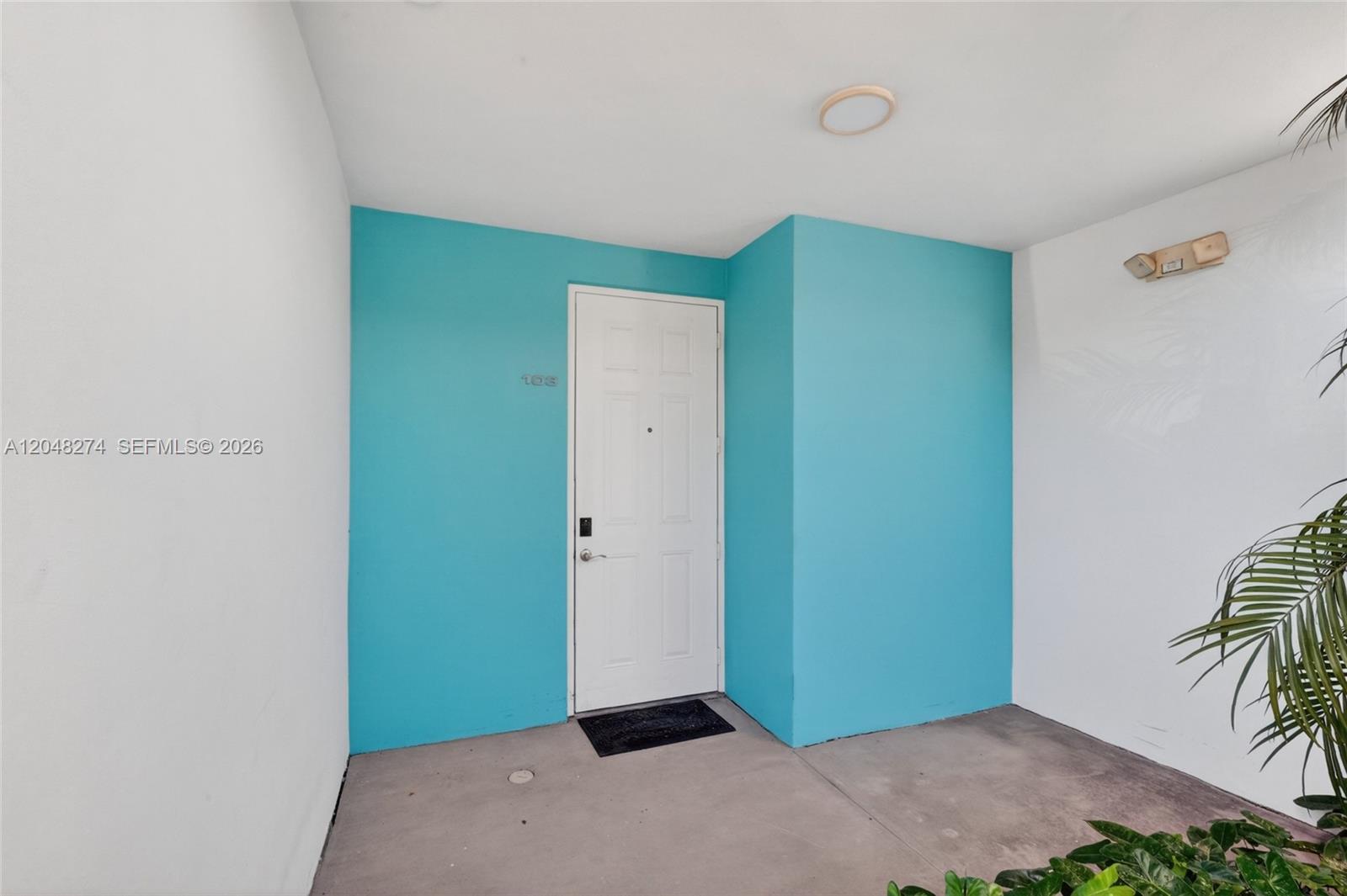 A white door with the number 108 is set into a bright turquoise wall — 652 NE 63rd St # 103, Miami FL 33138, MIAMI, FL