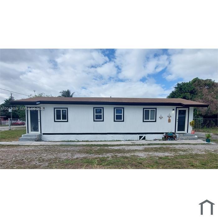 A single-story white house with a brown roof and black trim sits on a lot — 2927 NW 60th St, Miami FL 33142, MIAMI, FL