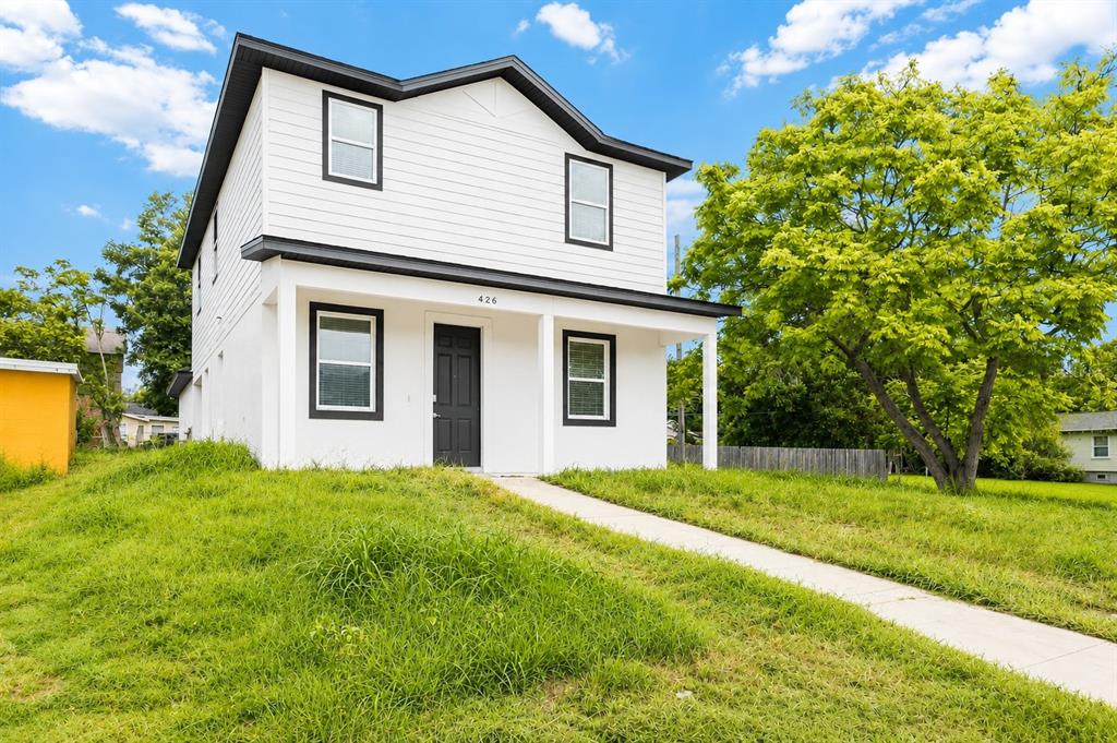 A two-story white house with a black front door and a concrete walkway — 426 S HUDSON STREET, ORLANDO, FL