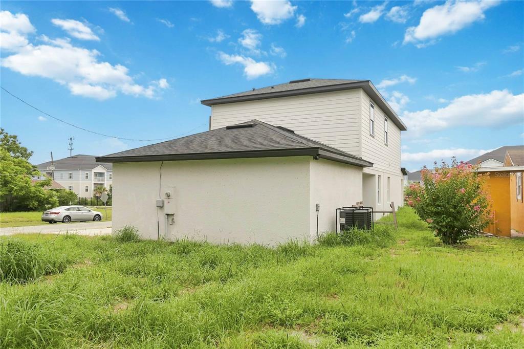 A covered concrete porch features a dark-framed window and a dark front door — 426 S HUDSON STREET, ORLANDO, FL
