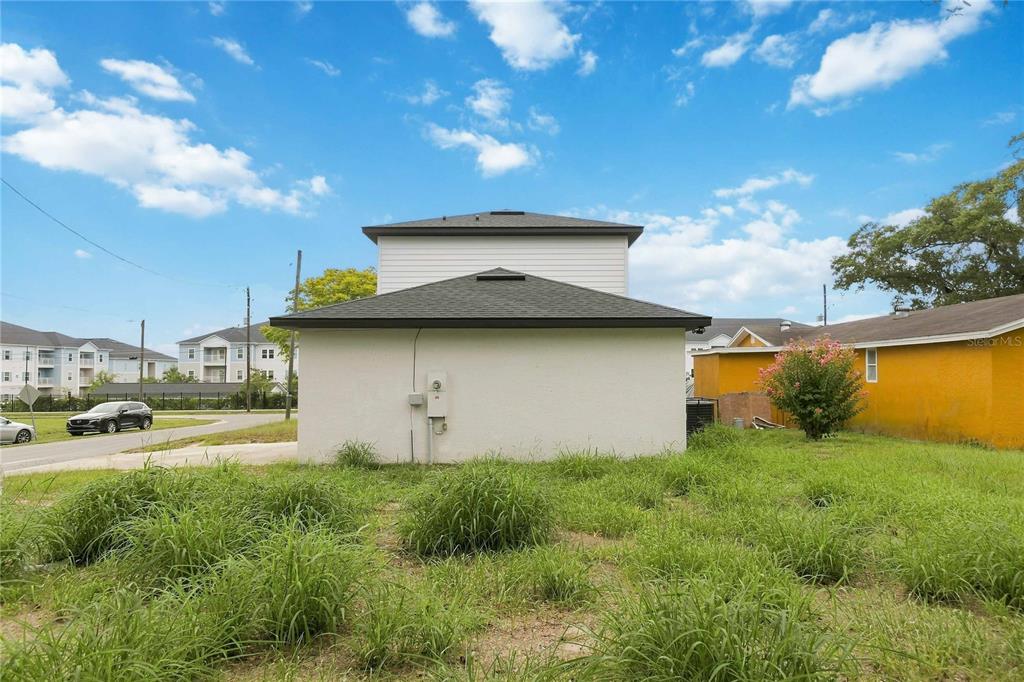 A white front door, a window with blinds, and stairs with wood-look flooring — 426 S HUDSON STREET, ORLANDO, FL
