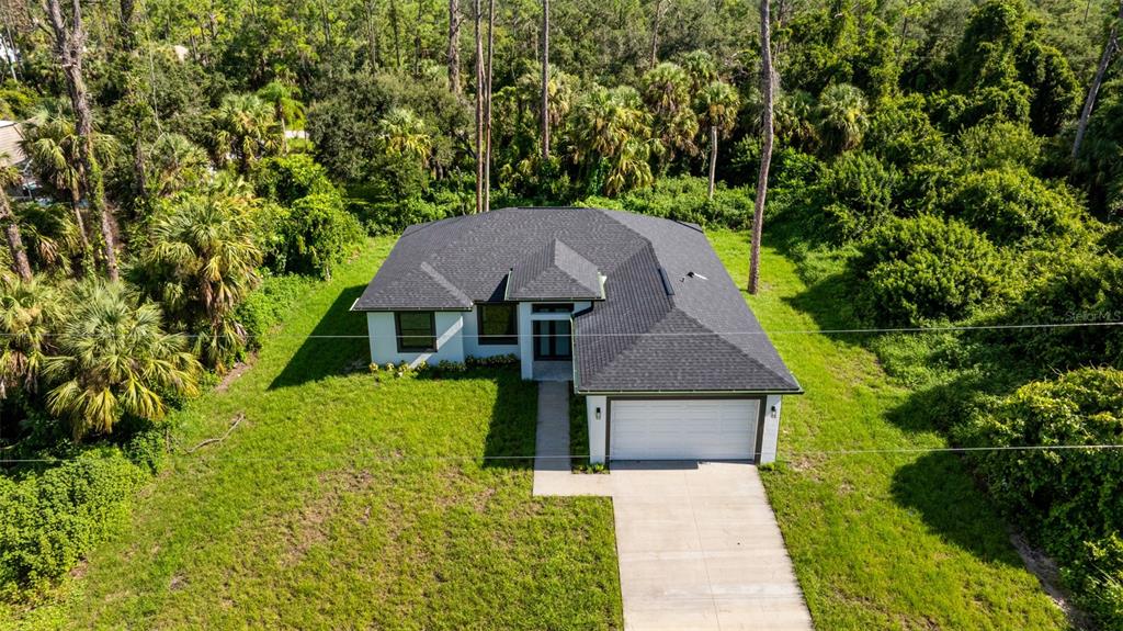 An aerial view of a single-story house with a dark roof and attached garage — 17196 GLENVIEW AVENUE, PORT CHARLOTTE, FL