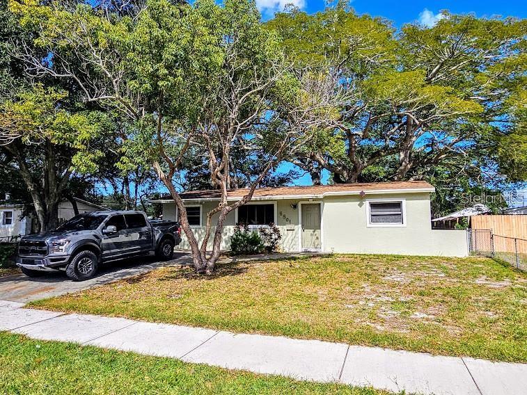A single-story house with a gray pickup truck parked in the front yard — 6801 79TH AVENUE N, PINELLAS PARK, FL