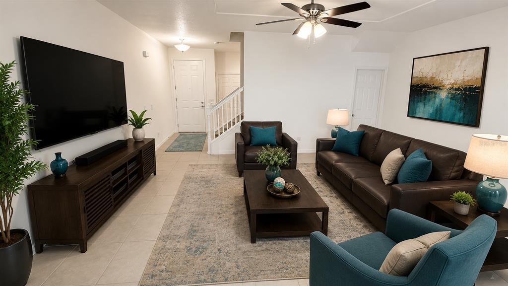 A living room features a large television, brown leather sofa, and teal accent chairs — 6910 TUSSILAGO WAY, ORLANDO, FL
