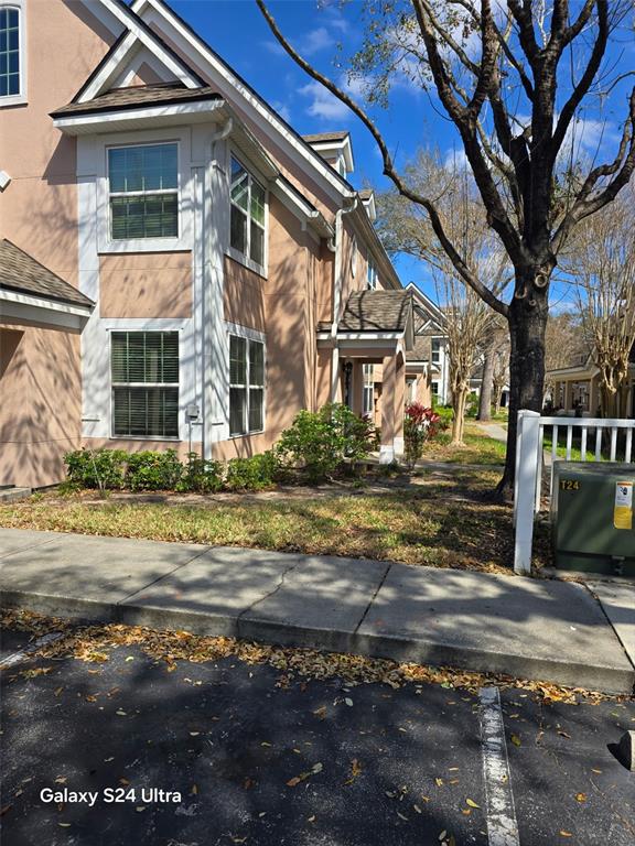 A multi-story tan townhouse exterior features white trim, multiple windows, and a small front porch — 3417 WESTCHESTER SQUARE BOULEVARD UNIT 204, ORLANDO, FL
