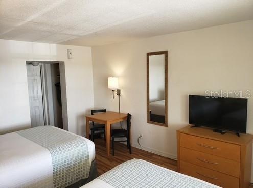 A hotel room featuring two beds, a small dining table with chairs, and a television — 1700 S ATLANTIC AVENUE, DAYTONA BEACH, FL
