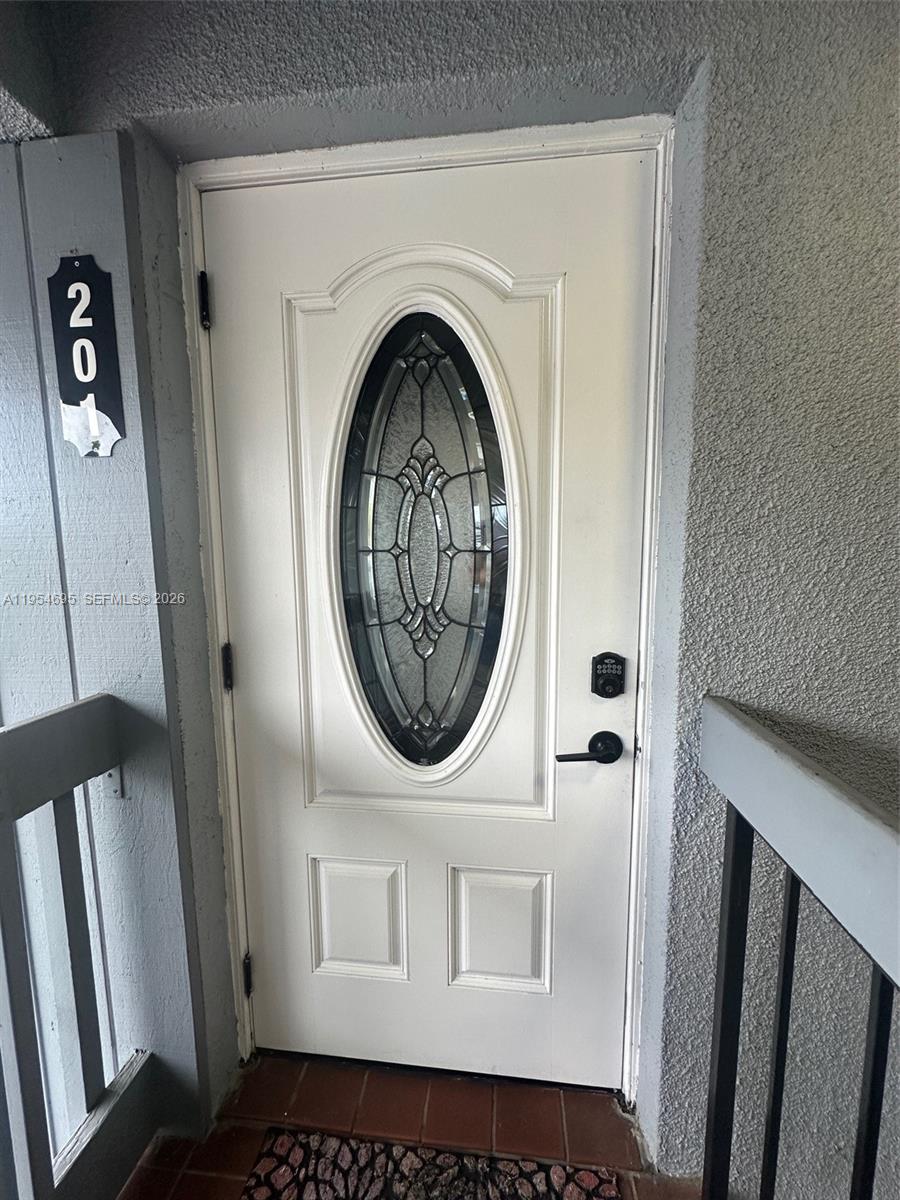 A white front door with an oval glass insert features a digital keypad lock — 13671 SW 62nd St # 1, Miami FL 33183, MIAMI, FL
