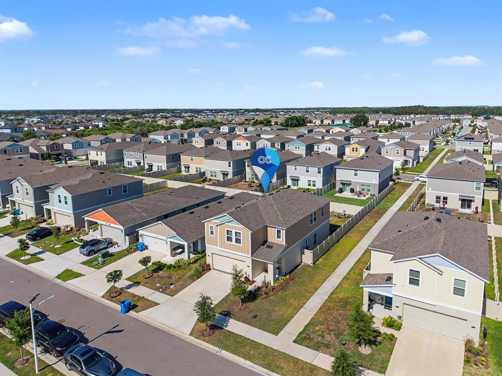 An aerial view shows a suburban neighborhood with detached houses and a blue location pin — 7587 STARFLOWER WAY, WESLEY CHAPEL, FL