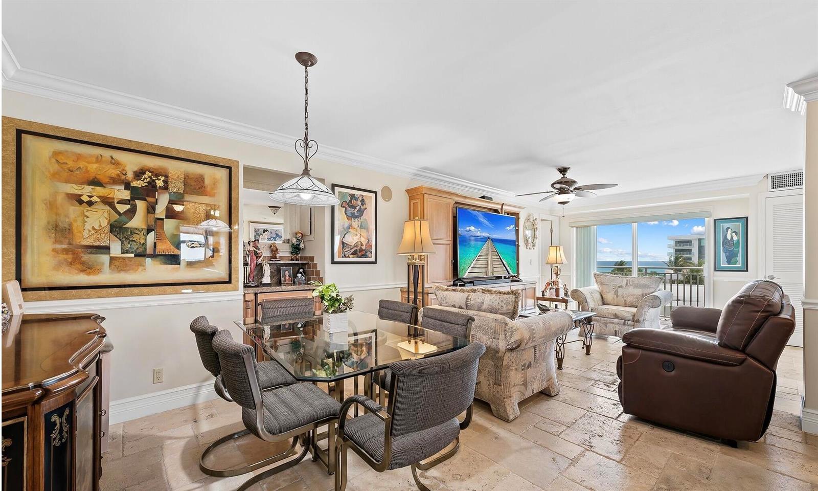 A living and dining area features tile floors, a glass-top table, and ocean views — 4511 S Ocean Boulevard # 601, Highland Beach FL 33487, HIGHLAND BEACH, FL