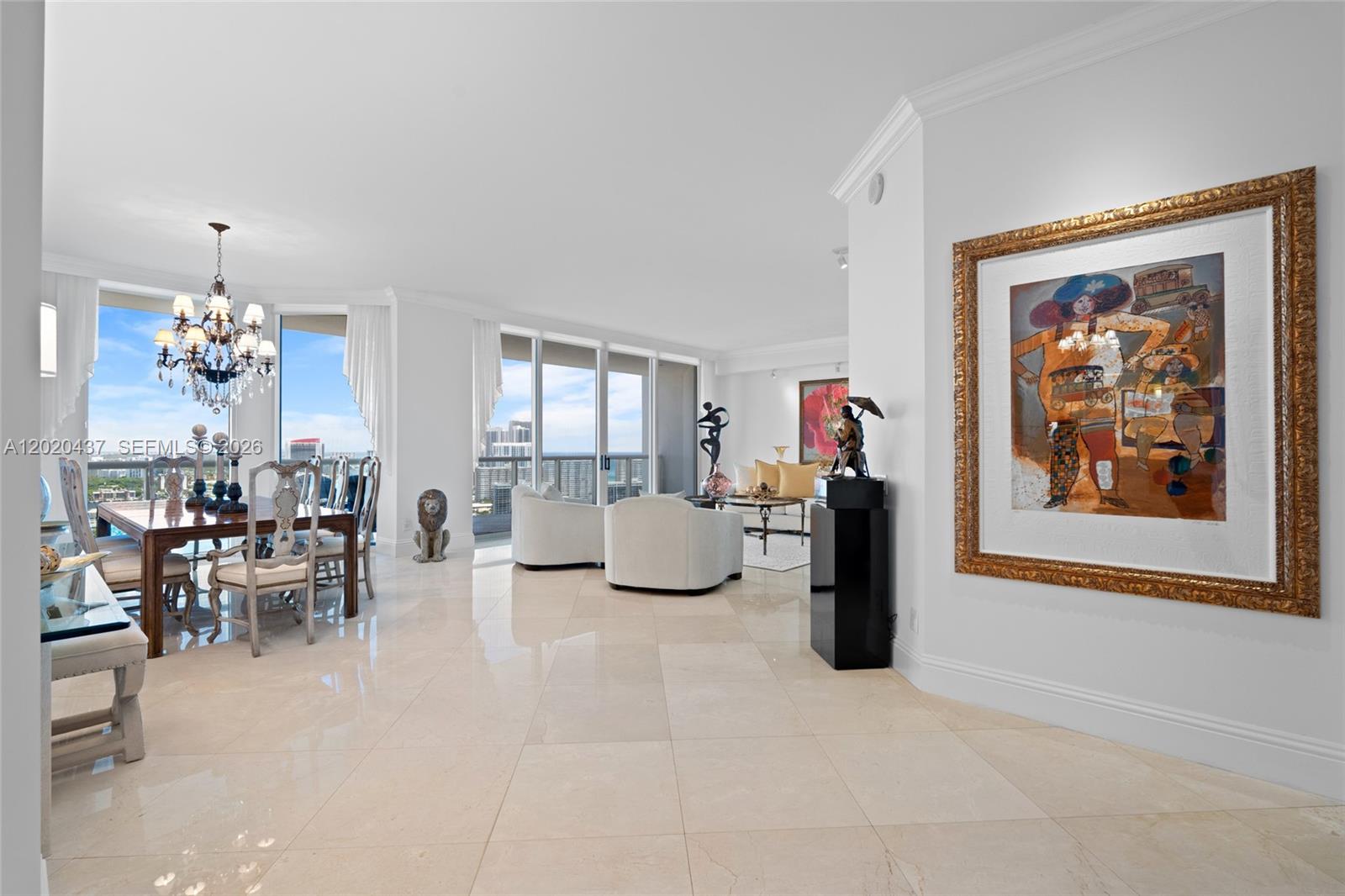 A bright, open-concept living and dining area features white tile floors and floor-to-ceiling windows — 21200 Point Pl # 2802, Aventura FL 33180, AVENTURA, FL
