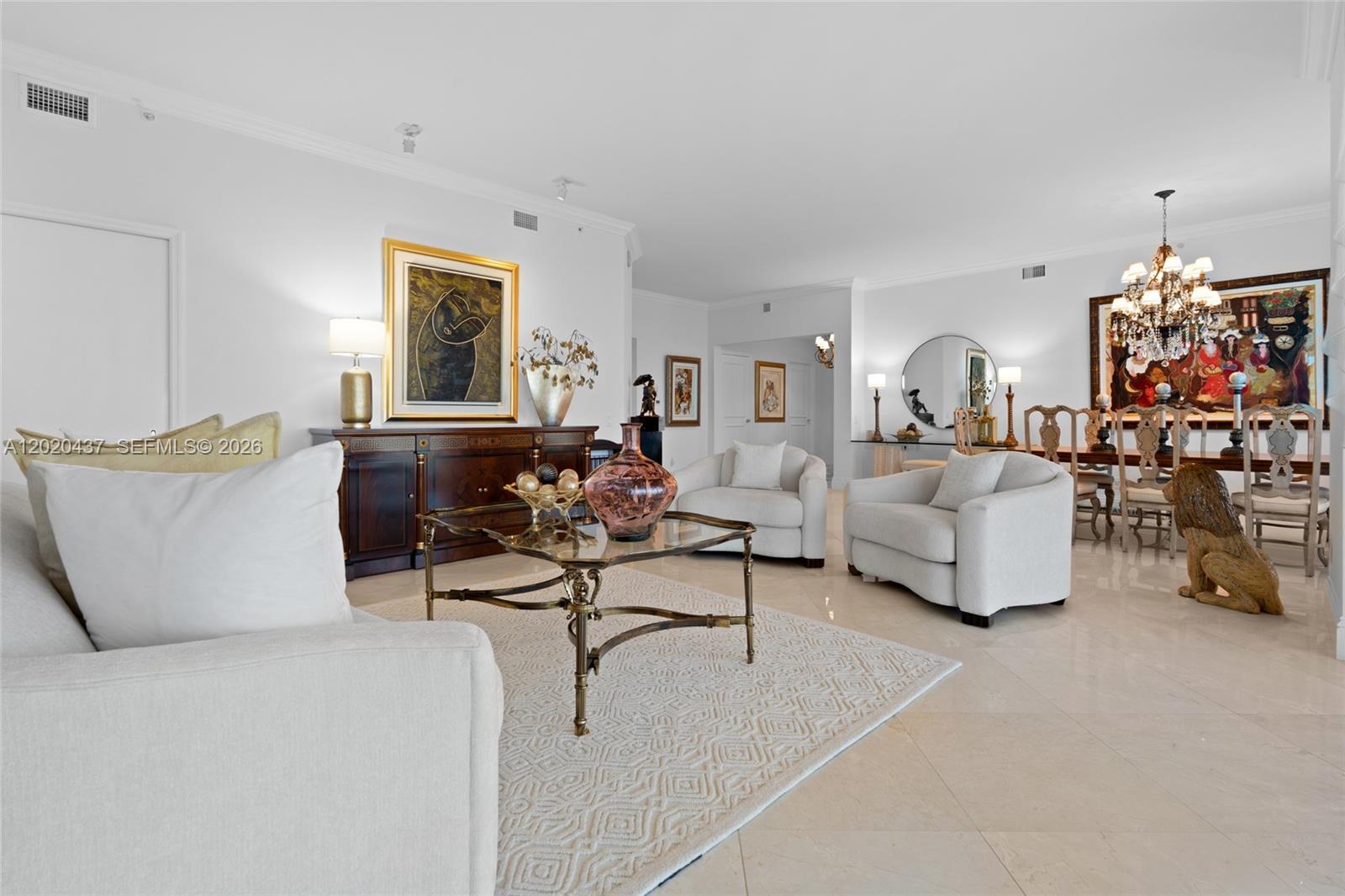 A spacious living and dining area features white furniture, a glass coffee table, and artwork — 21200 Point Pl # 2802, Aventura FL 33180, AVENTURA, FL