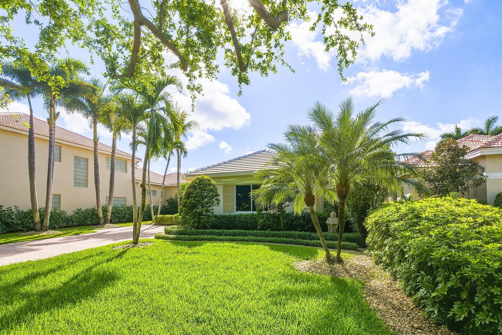 A single-story house with a paved driveway, palm trees, and a manicured lawn — 7011 Islegrove Place, Boca Raton FL 33433, BOCA RATON, FL